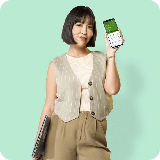 Mulher asiática segura um celular com o app PagBank aberto, representando autonomia para investir com carteiras recomendadas, diversificação e controle financeiro direto pelo aplicativo.