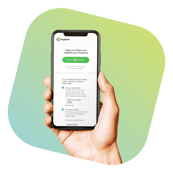 Mão segurando celular, app PagBank aberto na tela pagar com PagBank.
